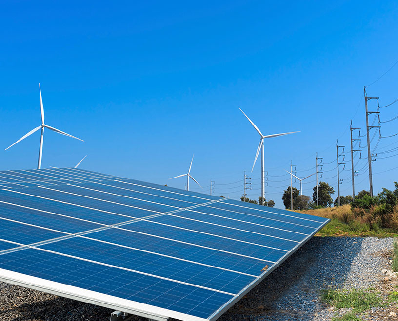 solar panels and wind turbines in a field